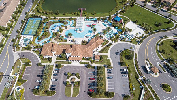 An aerial view of a resort with a large pool, multiple tennis courts, and a parking lot. - Splendid 5 Bd w Screened Pateo Pool Windsor Westside 8921 (Kissimmee)