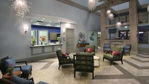 A spacious lobby with a reception desk, seating area, and decorative lighting. - Fabulous 5 Bedrooms Close to Disney at Champions Gate Resort 8988 (Kissimmee)