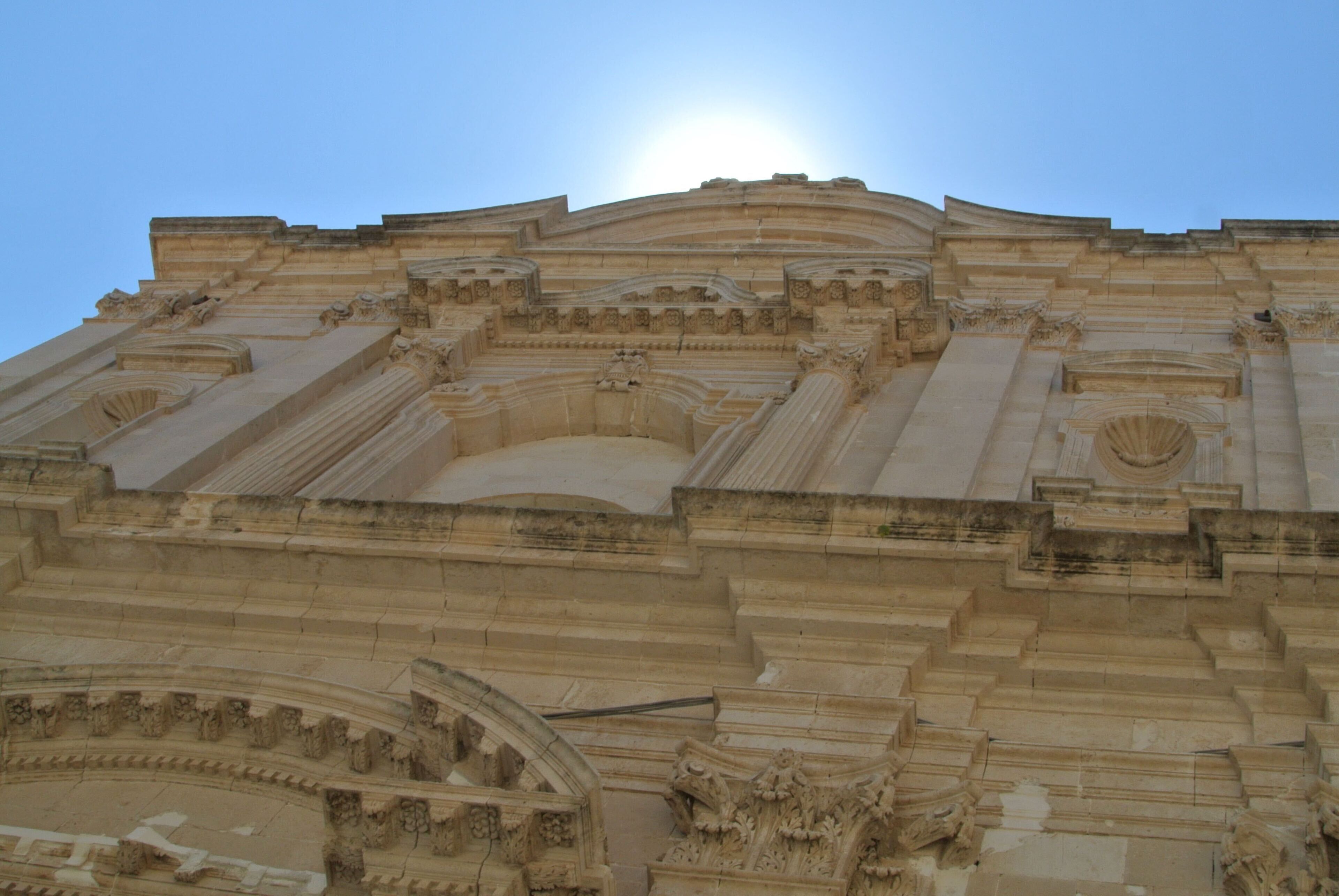 A grand architectural structure with intricate carvings and a prominent dome.