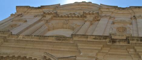 A grand architectural structure with intricate carvings and a prominent dome.