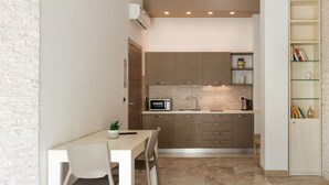 A compact kitchen with a microwave, sink, and a small dining area with a table and chairs. - Independent apartments/rooms  (Otranto)