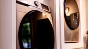 A wall-mounted washing machine in a bathroom. - Hollow Hideaway is just the place if you looking to get away and relax.   (Smithsburg)
