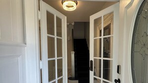 A hallway with white doors and a marble floor leading to a staircase. - Perfect for family/corporate, Strategic location, 2mi Yale, 2.8 mi Airport,  (New Haven)