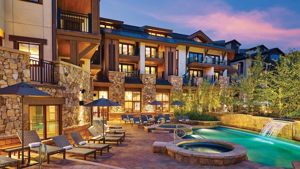 A resort with a pool, outdoor seating, and a waterfall. - Boutique Resort in Vail Village -  3 BR - 3BA Residence at The Sebastian (Vail)