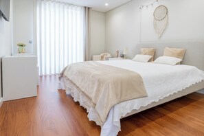 A bedroom with a bed, bedside table, and a nightstand.