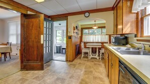 A kitchen with wooden cabinets, a dining table, and a built-in dishwasher. - 8 Mi to Elk Mountain Ski Resort: Clifford Home! (Clifford)