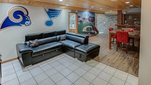 A modern living room with a sectional sofa, a dining table with chairs, and a fireplace. - Spacious Tranquility With Private Pool 4 Bedroom Home by RedAwning (Belleville)
