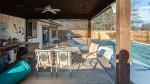 A covered patio with a pool table, chairs, and a ceiling fan. - Spacious Tranquility With Private Pool 4 Bedroom Home by RedAwning (Belleville)