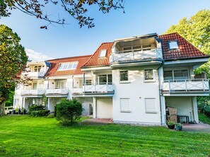 A two-story house with a red-tiled roof, white exterior walls, and a balcony on each floor. - Lamprecht by Interhome (Zinnowitz)