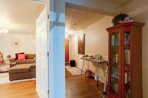 A living room with a sofa, a coffee table, and a cabinet.