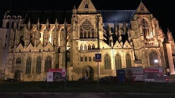 A large, historic building with Gothic architecture, including pointed arches and a large rose window.