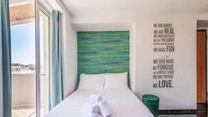 A modern hotel room with a large bed, a view of the city, and a motivational quote on the wall. - Beautiful View 8floor Loft Apartment in Athina (Athens)