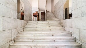 A marble staircase with a handrail, leading to a door at the top. - Beautiful View 8floor Loft Apartment in Athina (Athens)