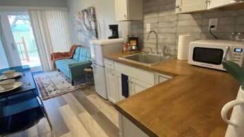 Fridge, microwave, coffee/tea maker, cookware/dishes/utensils