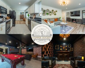 Une cuisine moderne avec des armoires blanches, un réfrigérateur noir et un sol à motifs. Le salon est doté d’un canapé gris, d’une table basse et d’un téléviseur. L’espace bar comprend une table de billard et un mur foncé à motifs.