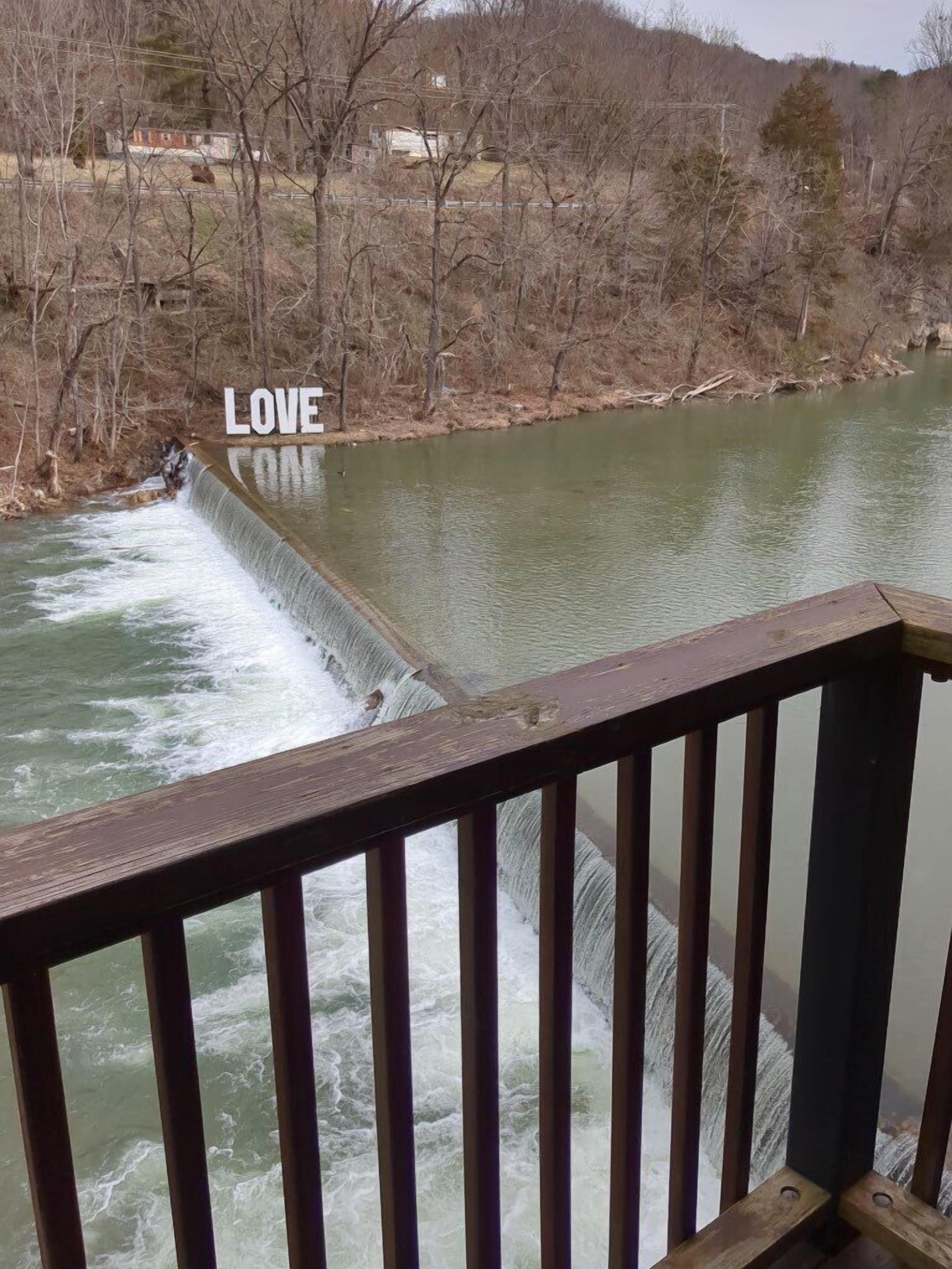 A river with a dam and the word "LOVE" on it.