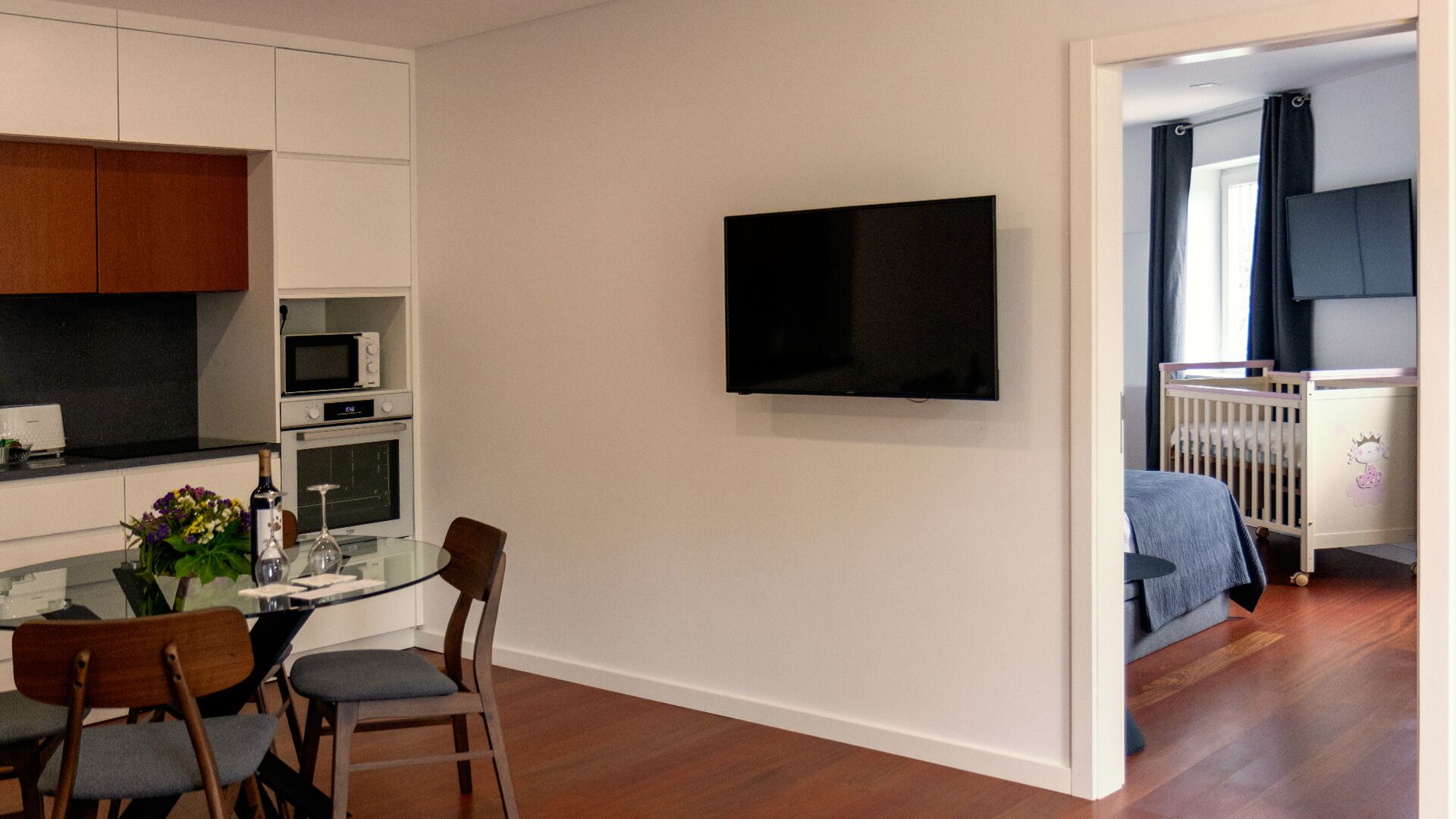 A compact living space with a kitchen, dining area, and a bedroom.