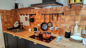 A kitchen with a wooden countertop, black cabinets, a stainless steel sink, and a range hood. -  [Historic Center] Elegance, WiFi, and A/C (Jesi)