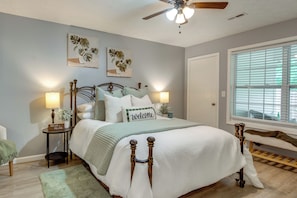 A bedroom with a bed, bedside tables, a ceiling fan, and a window with blinds. - Atlanta Getaway w/ Private Yard: Near Airport (Atlanta)