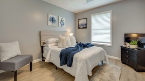 A bedroom with a bed, a chair, a dresser, and a ceiling fan. - Atlanta Getaway w/ Private Yard: Near Airport (Atlanta)