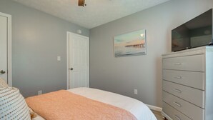 A bedroom with a bed, a dresser, a painting, and a ceiling fan. - Atlanta Getaway w/ Private Yard: Near Airport (Atlanta)