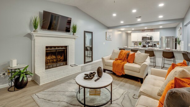 A spacious living room with a fireplace, a dining area, and a kitchen with modern appliances. - Atlanta Getaway w/ Private Yard: Near Airport (Atlanta)