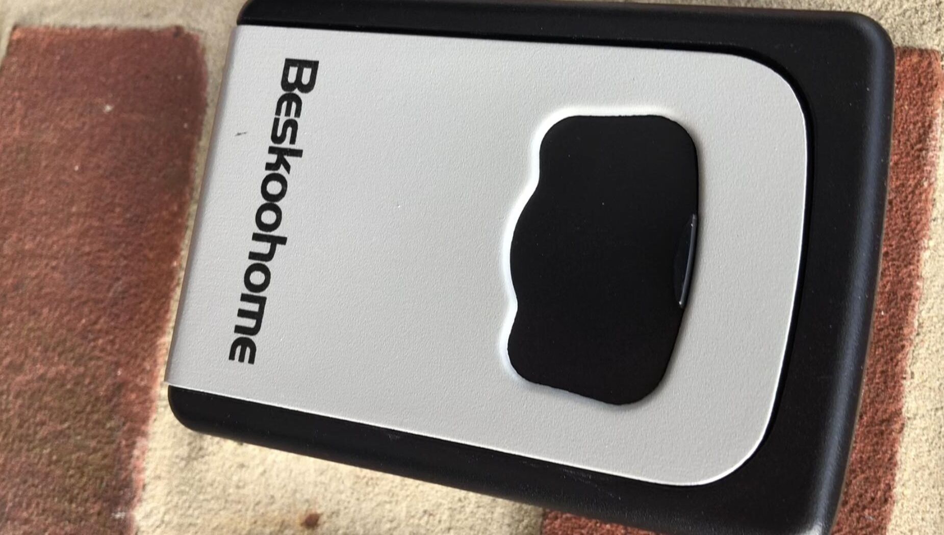 A black and white object with the text "Beskohome" on it.