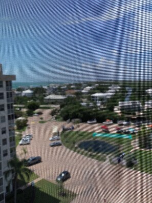 Enjoy a serene view of the parking area, water feature, and surrounding landscape from the comfort of your room.