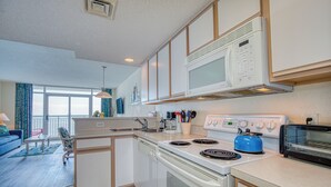 A modern kitchen with white appliances, a blue kettle, and a toaster. - Oceanfront 1BD-Baywatch Resort-Family Friendly (North Myrtle Beach)