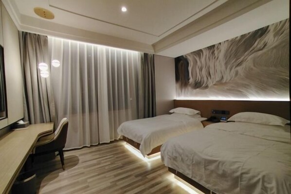 A hotel room with a desk, two beds, a large abstract wall art, and a view of the city through sheer curtains. - MAERkANG PO LING JIA SA HOTEL (Barkam)