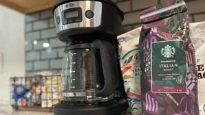 A Mr. Coffee coffee maker and a Starbucks Italian Roast coffee bag on a kitchen counter. - Cozy One Bedroom Apartment in Sheridan (Sheridan)