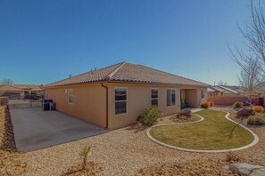 Stroll through the beautifully manicured lawn to the entrance of this charming single-story home.