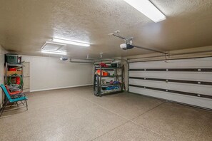Workshop space with workbench, shelving unit, and security system.