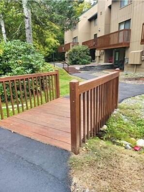 Walk across the pedestrian bridge to a serene residential complex with beautifully landscaped surroundings.