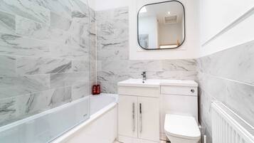 Shower, hair dryer, towels, shampoo