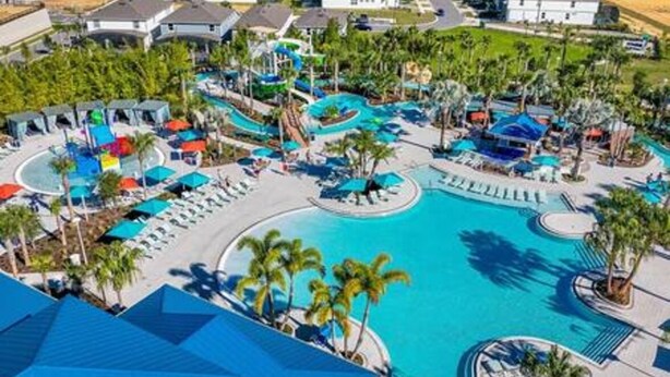 A resort with a large central pool, multiple smaller pools, and a variety of lounge areas.