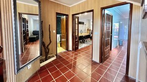 A hallway with a tiled floor, wooden doors, and a large mirror. - THE CORNER OF THE RIA (Torreira)