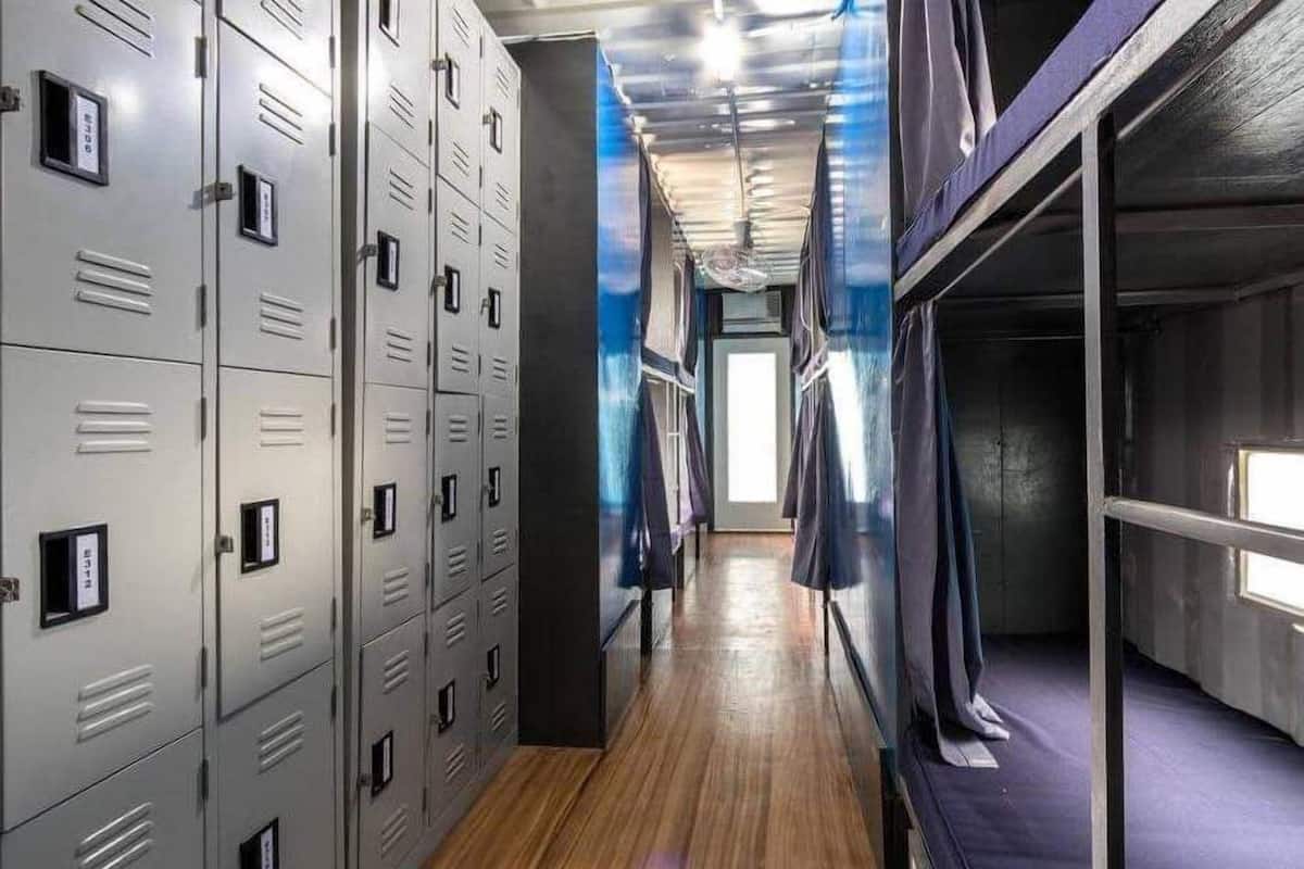 A hallway with lockers, a window, and a door at the end.