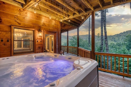 Outdoor spa tub. 4BR Pineview | Hot Tub & Scenic Views | Arcade