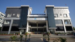 A modern building with a 'Dolphin' sign, featuring a symmetrical facade with large windows and a central entrance. - Dolphin club and Resort (Lucknow)