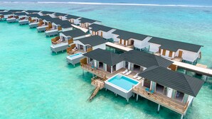 Overwater bungalows with private pools, connected by walkways, in a turquoise sea. - Joy Island  (Kasanfaru Island)