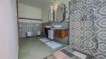 A bathroom with a shower, a sink, and a toilet.