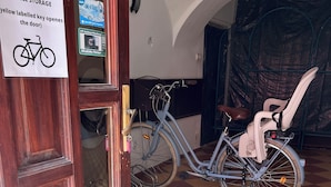 A bicycle storage area with a sign indicating a yellow key opens the door. - Győr (Gyor)