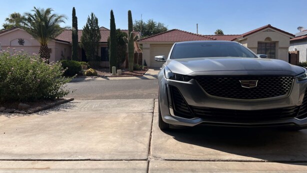 A residential driveway with a silver Cadillac parked in the foreground. - DesertOasis@ #LambertPark:4BD, Mtn Views, Gym, FREE Heated HOA Pool&Spa, PoolTable, CottonBedding (Tucson)
