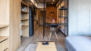 A compact living space with a kitchenette, a dining area, and a seating area.