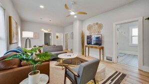 A modern living room with a sofa, coffee table, and a TV on a stand. - Teresa's Cottage - Walkable to downtown Sturgeon Bay (Sturgeon Bay)