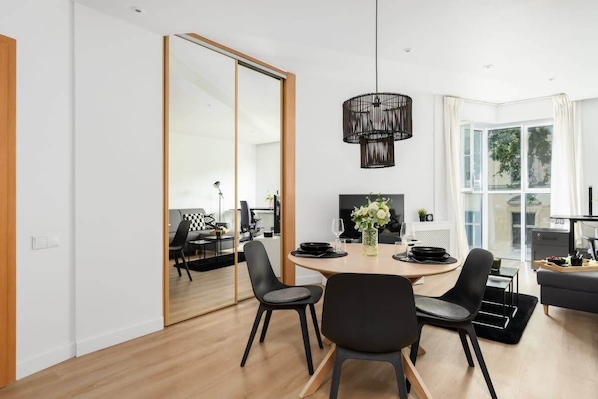 Dining area connected to the living room, offering a seamless and spacious layout.

