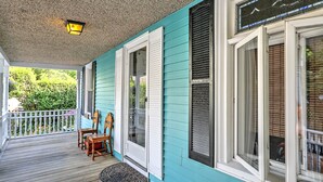A porch with a wooden floor, a small table, and two chairs. - Private Gem in Heart of Downtown Newport  (Newport)