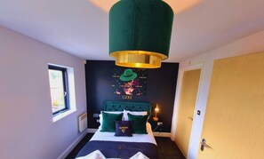 Une chambre d’hôtel avec un lit, une fenêtre, une œuvre d’art accrochée au mur et une porte.