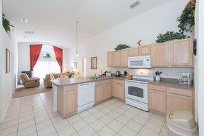 Enjoy cooking in this well-equipped kitchen with appliances and a central island.